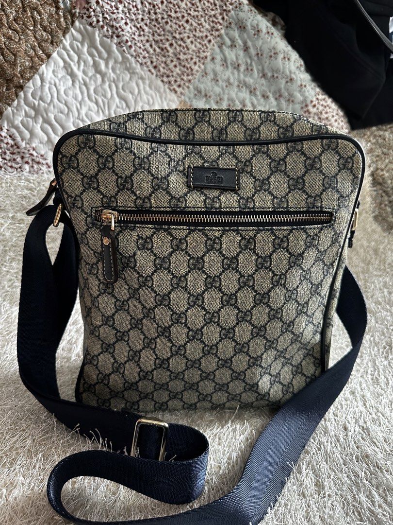 Gucci GG Supreme Canvas Messenger Bag (Category: Luxury Bags & Wallets) located in Manila. Submitted by aisasalvad24335 (Listing ID 1465802282, Image 1). Description: - Authentic Gucci messenger bag in classic GG Supreme canvas - Dark blue adjustable shoulder strap with premium gold-tone hardware - Convenient front zippered pocket with leather pull tab - Clean brown fabric interior lining with an additional zippered pocket - Features official deb
