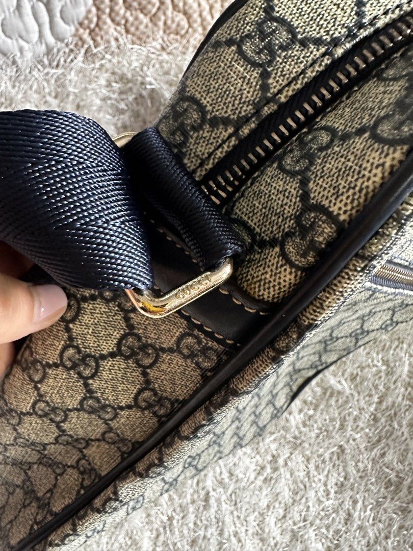 Gucci GG Supreme Canvas Messenger Bag (Category: Luxury Bags & Wallets) located in Manila. Submitted by aisasalvad24335 (Listing ID 1465802282, Image 3). Description: - Authentic Gucci messenger bag in classic GG Supreme canvas - Dark blue adjustable shoulder strap with premium gold-tone hardware - Convenient front zippered pocket with leather pull tab - Clean brown fabric interior lining with an additional zippered pocket - Features official deb