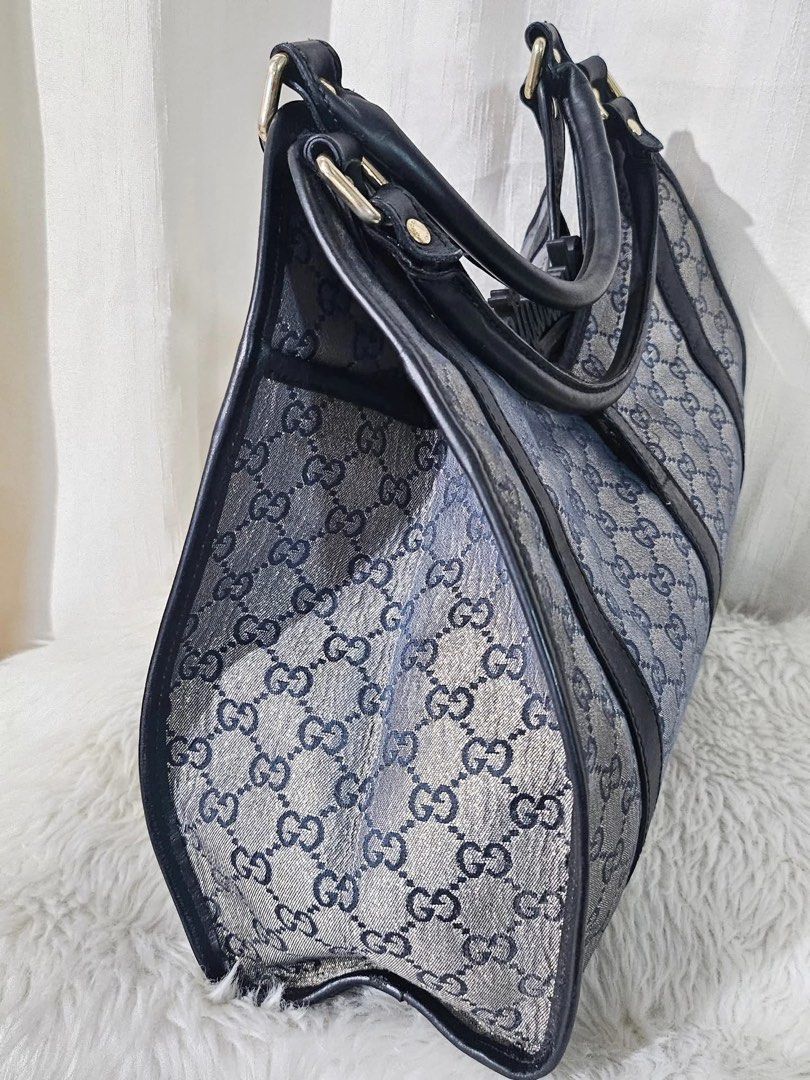 Gucci Monogram Canvas Shoulder Tote Bag (Category: Luxury Bags & Wallets) located in Pamplona. Submitted by luxuryitems_ph (Listing ID 1465866795, Image 3). Description: - Authentic vintage Gucci monogram canvas tote in blue and grey - Premium black leather handles, trim, and dark edge piping - Distinctive metal clasp closure on the front - Structured silhouette with sturdy double straps - Clean and spacious interior - Timeless Italian luxury pie