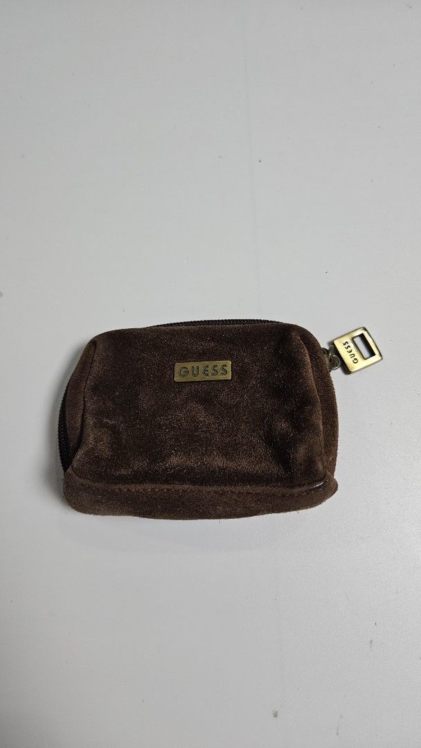 Guess Brown Suede Coin Purse Pouch (Category: Purses & Pouches) located in Alfonso. Submitted by jbcamet (Listing ID 1465923943, Image 1). Description: - Brand: Guess - Material: Real leather suede exterior with polyester lining - Color: Brown with brass hardware - Closure: Secure zipper with Guess logo pull - Features: Rectangular shape, front Guess logo plaque, and interior key ring - Condition: Great for organizing loose change and small essen