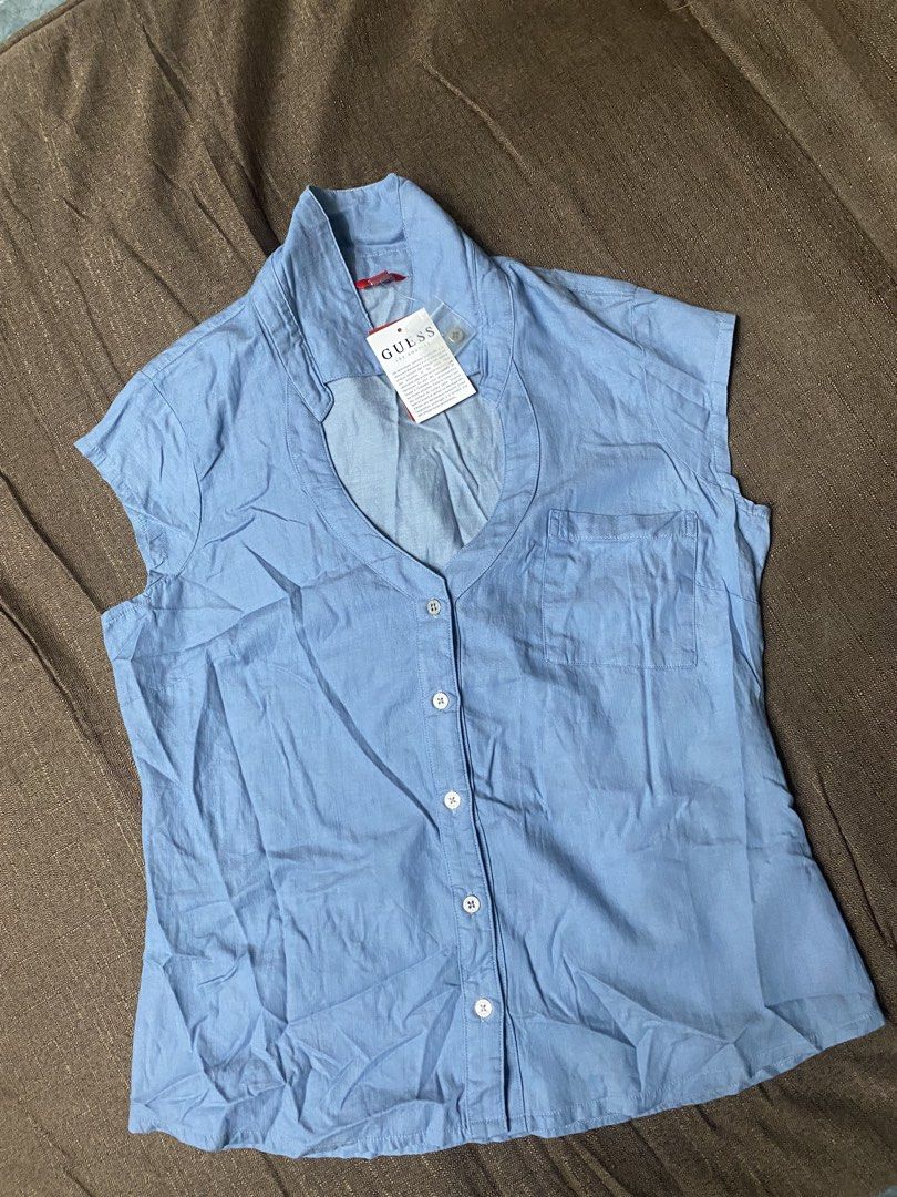 Guess Los Angeles Marlowe Chambray Top (Category: Sleeveless) located in Quezon City. Submitted by mt031199 (Listing ID 1465946748, Image 2). Description: - Brand: Guess Los Angeles - Color: Light blue (denim-look) - Style: Sleeveless button-up with classic collar and front chest pocket - Condition: Brand new with original tag attached - Material: Lightweight and comfortable - Perfect casual everyday piece!.