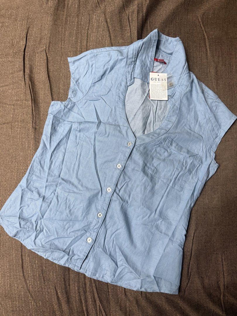 Guess Los Angeles Marlowe Chambray Top (Category: Sleeveless) located in Quezon City. Submitted by mt031199 (Listing ID 1465946748, Image 3). Description: - Brand: Guess Los Angeles - Color: Light blue (denim-look) - Style: Sleeveless button-up with classic collar and front chest pocket - Condition: Brand new with original tag attached - Material: Lightweight and comfortable - Perfect casual everyday piece!.