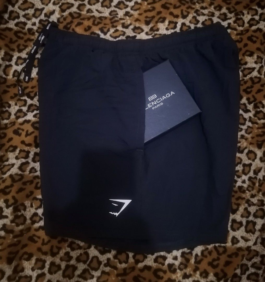 Gymshark Black Athletic Shorts with Drawstrings (Category: Shorts) located in Cebu City. Submitted by roadthrift (Listing ID 1465815698, Image 2). Description: - Brand: Gymshark - Color: Classic Black - Material: Lightweight, breathable fabric ideal for workouts and running - Design: Elastic waistband with adjustable branded drawstrings - Detail: White Gymshark sharkhead logo on the bottom left hem - Condition: Excellent / Ready for the gym bag.