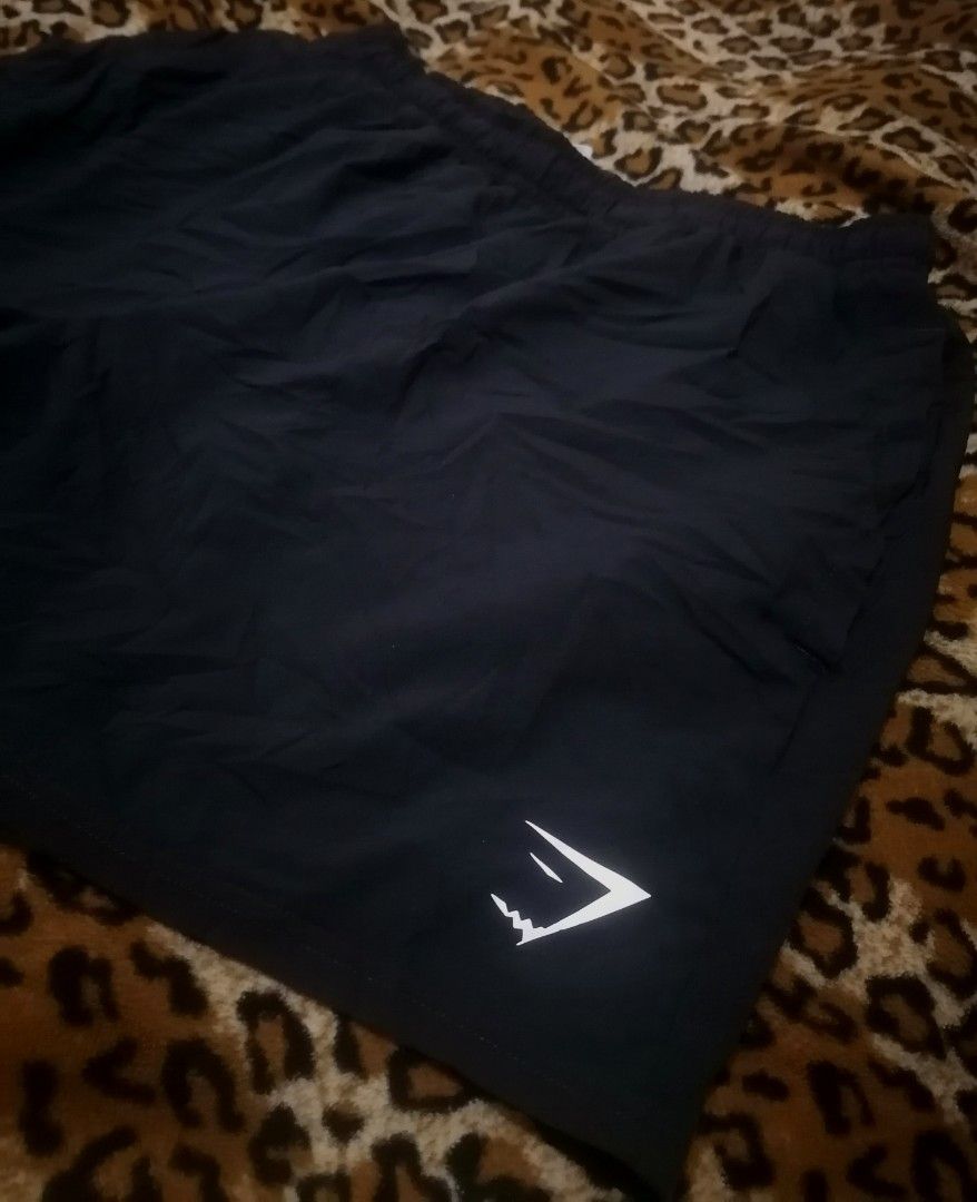 Gymshark Black Athletic Shorts with Drawstrings (Category: Shorts) located in Cebu City. Submitted by roadthrift (Listing ID 1465815698, Image 3). Description: - Brand: Gymshark - Color: Classic Black - Material: Lightweight, breathable fabric ideal for workouts and running - Design: Elastic waistband with adjustable branded drawstrings - Detail: White Gymshark sharkhead logo on the bottom left hem - Condition: Excellent / Ready for the gym bag.