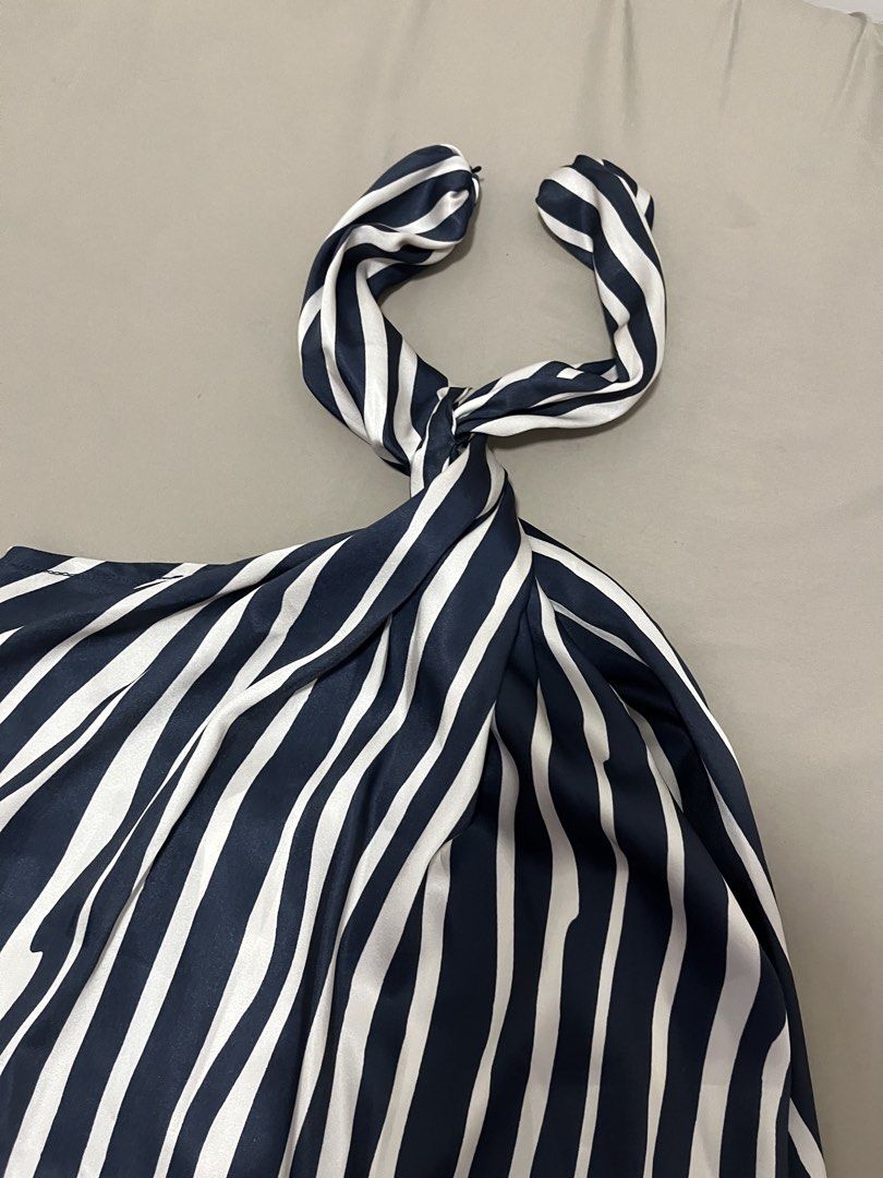 Halter top (Category: Sleeveless) located in Marikina City. Submitted by maicsg_ (Listing ID 1465772283, Image 3). Description: - Black and white striped halter top - Stylish twisted knot detail at the front - Back collar button closure with two black buttons - Silky smooth fabric with subtle vertical stripes - Easy to pair with shorts or skirts for a casual look.