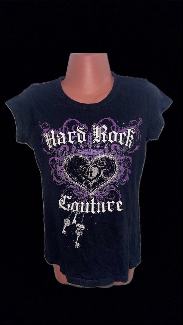 Hard Rock Cafe Couture Black Graphic Tee (Category: Tshirts & Polo Shirts ) located in Manila. Submitted by fastforest_65f95b (Listing ID 1465806121, Image 1). Description: - Brand/Style: Hard Rock Couture graphic t-shirt - Color: Classic black - Design: Eye-catching white and purple front print with scrollwork, crown, heart lock, and skeleton keys - Fit & Comfort: Casual fit made from soft, breathable cotton - Styling: Versatile piece, easy to m