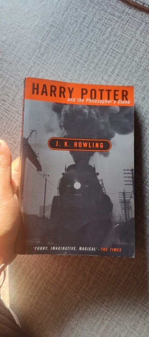 Harry Potter and the Philosopher's Stone by J.K. Rowling (Category: Storybooks) located in Paranaque City. Submitted by Jhayous (Listing ID 1465764371, Image 1). Description: - Title: Harry Potter and the Philosopher's Stone - Author: J.K. Rowling - Format: Paperback - Cover Art: Iconic train cover with classic B&W photography - Condition: Clean pages, well-maintained, ready for a new owner - Age Group: Perfect for kids, teens, and adults alike -