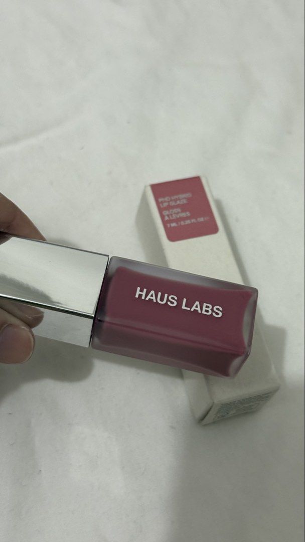 Haus Labs PhD Hybrid Lip Glaze Macaron (Category: Makeup) located in Valenzuela. Submitted by alexinelg (Listing ID 1465936449, Image 2). Description: - Brand: Haus Labs - Product: PhD Hybrid Lip Glaze - Shade: Macaron - Volume: 7 ml / 0.25 fl oz - Condition: Brand new, unopened, with original outer box - Packaging: Clean white exterior with product label details on top.