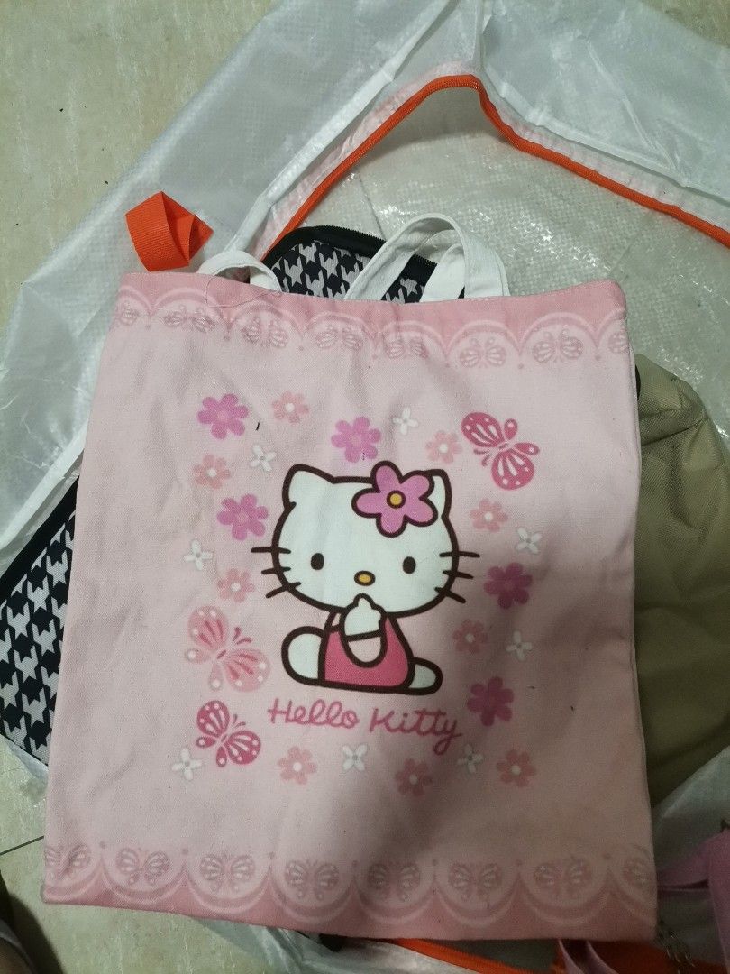 Hello Kitty Lunch Bag and Tote Bag Set (Category: Tote Bags) located in Makati City. Submitted by kookybearsstuff (Listing ID 1465831669, Image 3). Description: - Authentic Sanrio Kitty bundle including a lunch bag and matching tote - Lunch bag features a stylish black and pink houndstooth pattern with an insulated silver interior to keep food fresh - Matching pink canvas tote comes with a secure zipper closure - Adorned with cute flower and hear