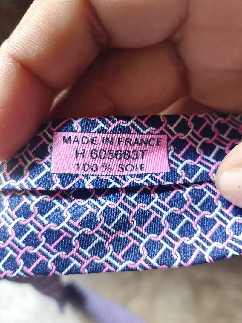 Hermès Paris Silk Tie Blue Pink Chain Link Pattern (Category: Ties) located in Caloocan City. Submitted by christian.35 (Listing ID 1465788821, Image 3). Description: - Brand: Hermès Paris (Made in France) - Material: 100% Silk - Color/Pattern: Deep blue base with pink, white, and purple chain link design - Features: Standard width, horse and carriage brand label on keeper loop and interior tail - Condition: Great, clean condition - Care: Dry cle