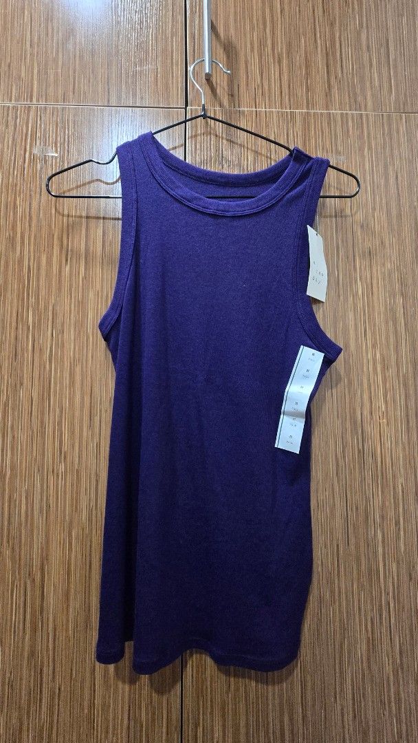 High neck tank top (Category: Sleeveless) located in Cebu City. Submitted by kitty_12345_ (Listing ID 1465878995, Image 1). Description: - Brand: A New Day - Size: Medium (M) - Color: Purple - Style: Crew neck, sleeveless, ribbed tank top - Material: Soft, stretchy cotton blend - Condition: Brand new with original tags attached - Versatility: Great basic piece for layering or wearing on its own MOP: gcash, mari, maya, gotyme MOD: Lbc, maxim Meetu