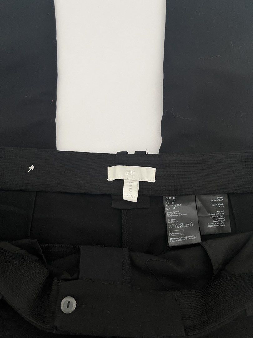 H&M Black Trousers (Category: Trousers) located in Quezon City. Submitted by cooperminie (Listing ID 1465816088, Image 3). Description: - Brand: H&M - Color: Black - Style: Regular fit trousers with button closure and belt loops (stretchy) - Pockets: Back welt pockets included - Size: EUR 46 / US 14 / UK 18 - Material: 50% polyester, 47% cotton blend (Made in Myanmar) - Condition: Clean, excellent, and ready to wear for work or casual outings.