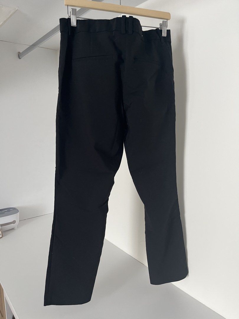H&M Black Trousers (Category: Trousers) located in Quezon City. Submitted by cooperminie (Listing ID 1465816088, Image 2). Description: - Brand: H&M - Color: Black - Style: Regular fit trousers with button closure and belt loops (stretchy) - Pockets: Back welt pockets included - Size: EUR 46 / US 14 / UK 18 - Material: 50% polyester, 47% cotton blend (Made in Myanmar) - Condition: Clean, excellent, and ready to wear for work or casual outings.