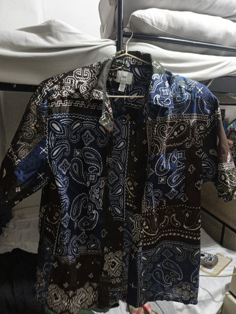 H&M Paisley Patchwork Print Short Sleeve Shirt (Category: Shirts) located in Las Pinas. Submitted by sebastians42444 (Listing ID 1465912914, Image 1). Description: - Brand/Style: H&M short sleeve button-down shirt - Design: Blue, brown, and white paisley patchwork all over - Details: Standard collar and single left chest pocket - Fit/Fabric: Lightweight fabric with a relaxed, regular fit - Styling: Great summer piece, easy to match with plain sho