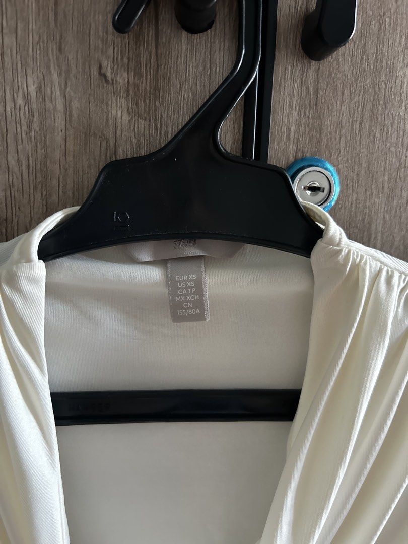 H&M White Draped Bodysuit Size XS (Category: Blouses) located in Makati City. Submitted by magwayr19 (Listing ID 1465769999, Image 2). Description: H&M - Style: Sleeveless bodysuit with draped neckline and side gathering - Size: Extra Small (XS) .
