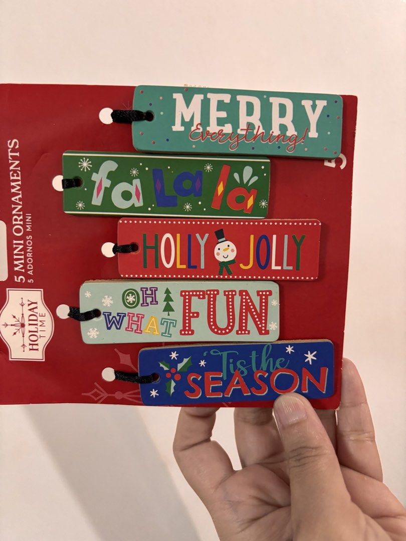 Holiday Time 5 Mini Ornaments Christmas Set (Category: Vintage Collectibles) located in Quezon City. Submitted by onlinebazaare (Listing ID 1465932877, Image 2). Description: - Brand: Holiday Time - Set of 5 wooden rectangular mini ornament tags - Festive phrases: Merry Everything, Fa La La, Holly Jolly, Oh What Fun, Tis the Season - Includes hanging string for easy display - Brand new on original store backing - Versatile use: ideal for small Ch