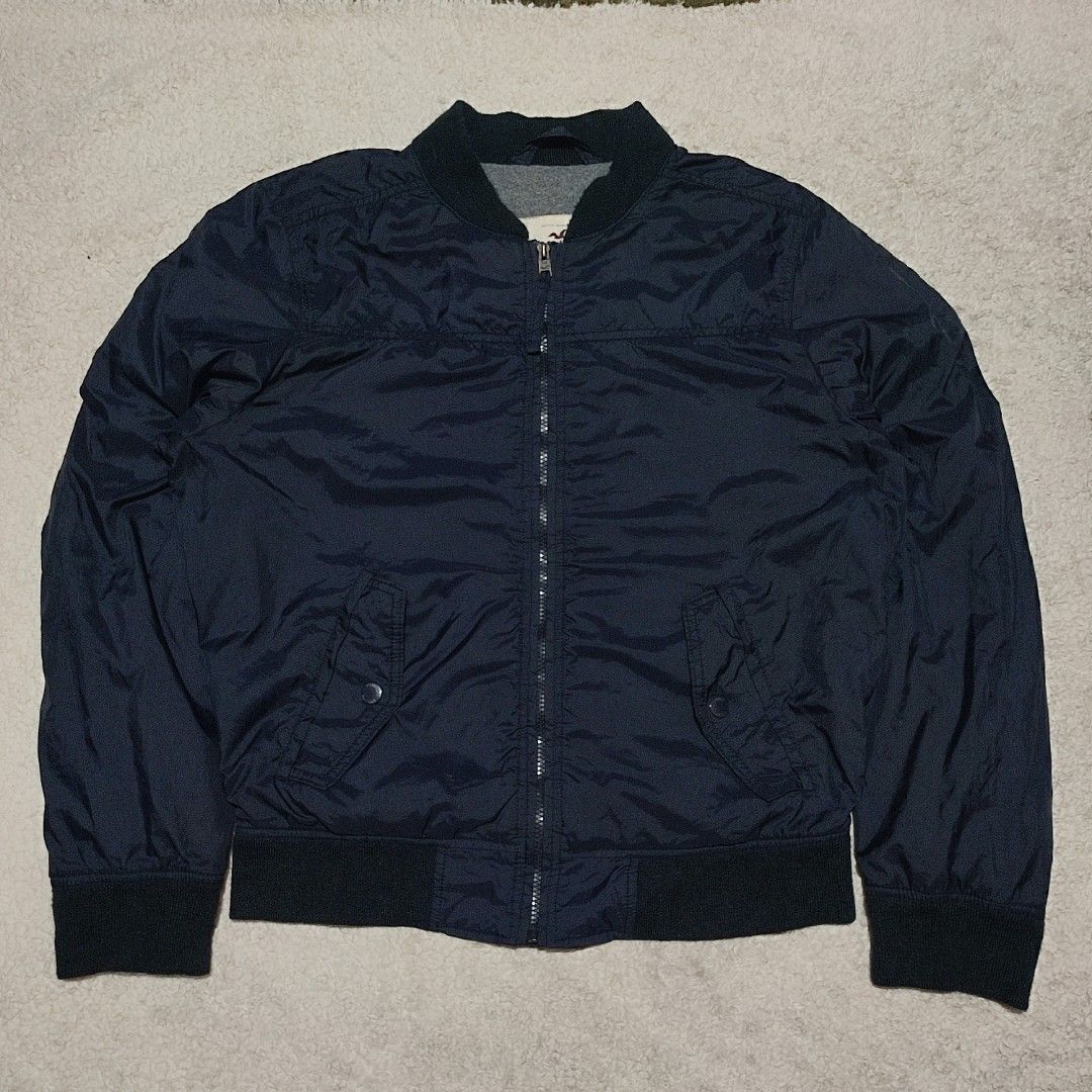 Hollister Navy Blue Bomber Jacket (Category: Coats, Jackets and Outerwear) located in Manila. Submitted by anthonig (Listing ID 1465872662, Image 1). Description: Color may vary due to lighting Length: 25.5 inches Width: 24 inches Price: 400 pesos Condition: 9.6/10 Issues: none PM if interested or for inquiries Meetups within MANILA only Can do shipping at buyers expense.