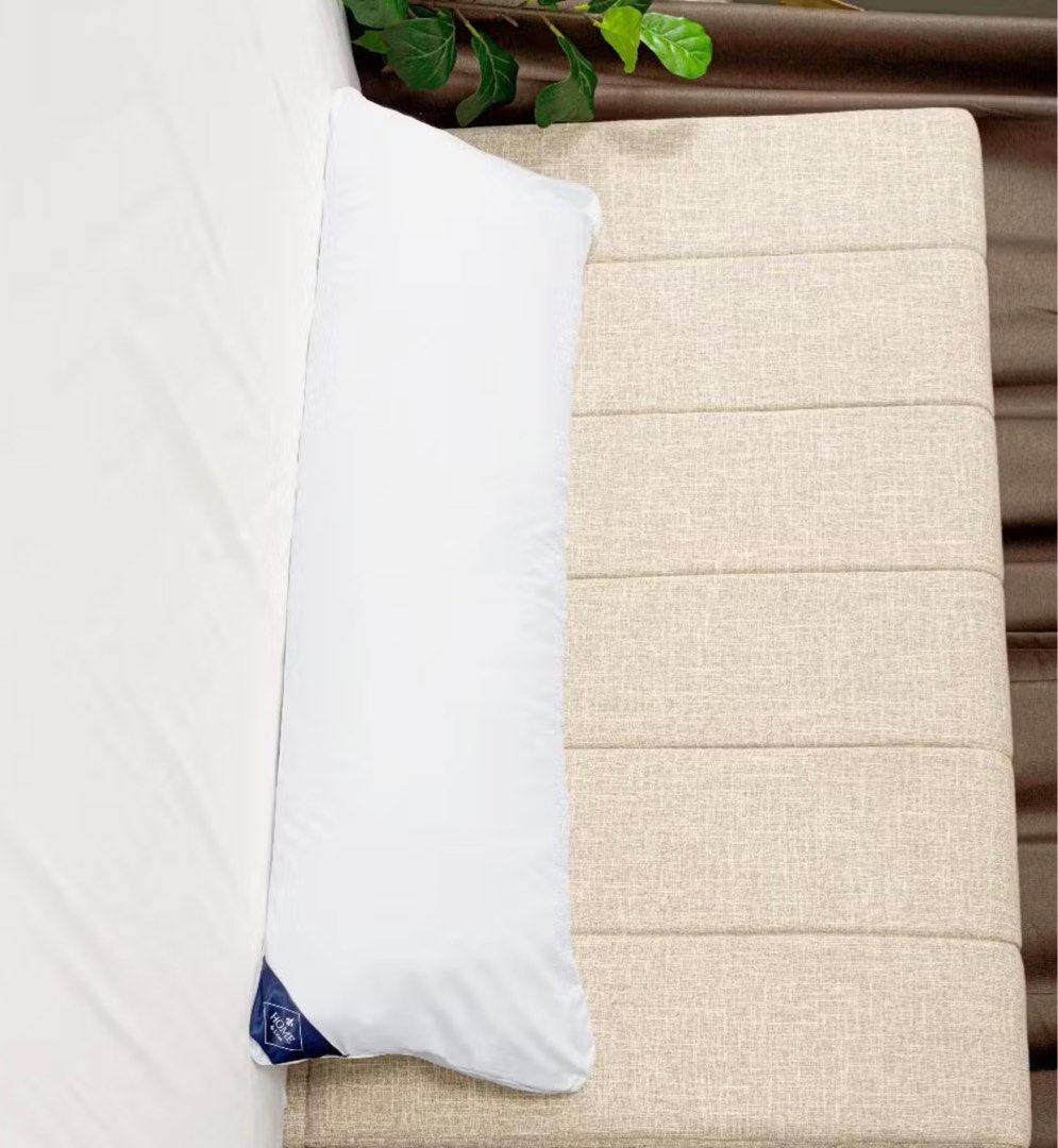 Home de Luxe White Bolster Pillow (Category: Bedding & Towels) located in Manila. Submitted by decluterthings888 (Listing ID 1465879363, Image 1). Description: - Color: Clean white - Brand: Home de Luxe (with blue tag) - Shape: Long cylindrical - Ideal for: Sleeping or lounging on the bed - Condition: Soft and plush.