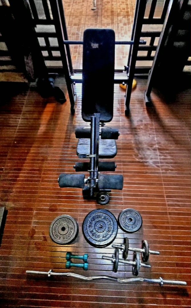 Home gym workout bench with weights and barbell (Category: Weights & Dumbbells) located in Mandaluyong City. Submitted by jc.regala (Listing ID 1465865177, Image 2). Description: - Complete home workout setup including bench, bars, and weights - Heavy-duty metal frames with comfortable padded bench - Space-saving design ideal for garage gyms or spare rooms - Includes adjustable weight bench, barbell, curl bar, dumbbell handles, and plates - Every