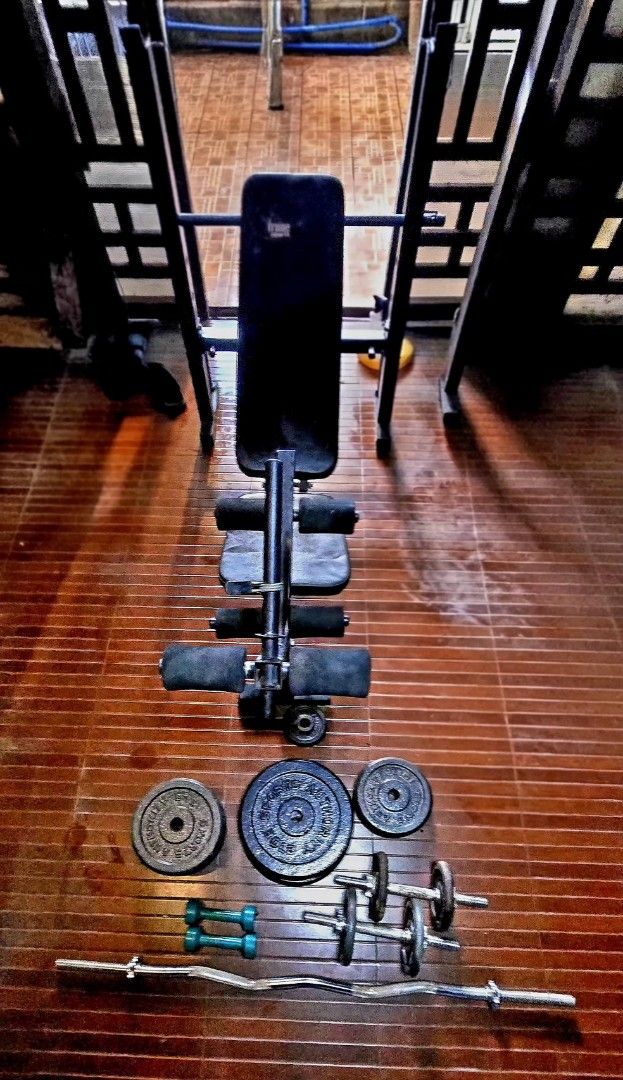 Home gym workout bench with weights and barbell (Category: Weights & Dumbbells) located in Mandaluyong City. Submitted by jc.regala (Listing ID 1465865177, Image 1). Description: - Complete home workout setup including bench, bars, and weights - Heavy-duty metal frames with comfortable padded bench - Space-saving design ideal for garage gyms or spare rooms - Includes adjustable weight bench, barbell, curl bar, dumbbell handles, and plates - Every