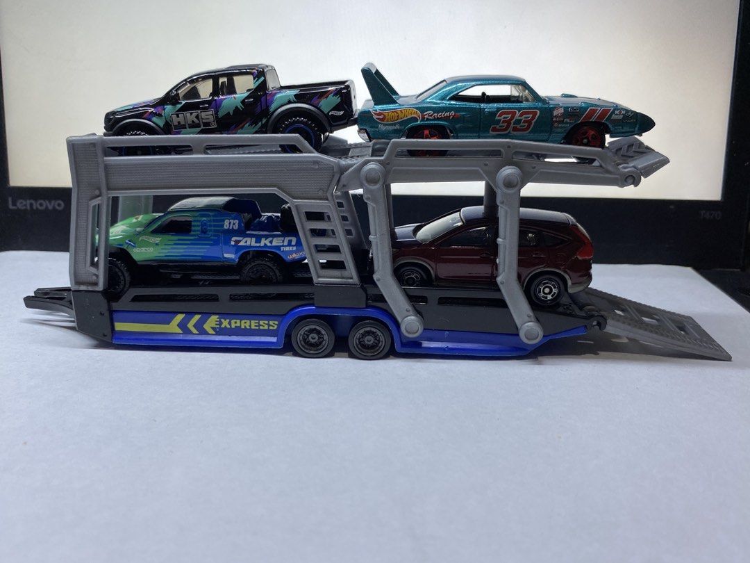 Hot Wheels Express Multi-Car Transport Trailer Set (Category: Vehicle & Diecast Models) located in Paranaque City. Submitted by marcobotin (Listing ID 1465945573, Image 1). Description: - Blue and black car hauler - Adjustable upper deck: Moves up and down for realistic loading and display - Fold-down rear ramps: Makes loading and unloading cars quick and easy - Smooth-rolling wheels: Great for active play or display setups - Diecast cars not inc
