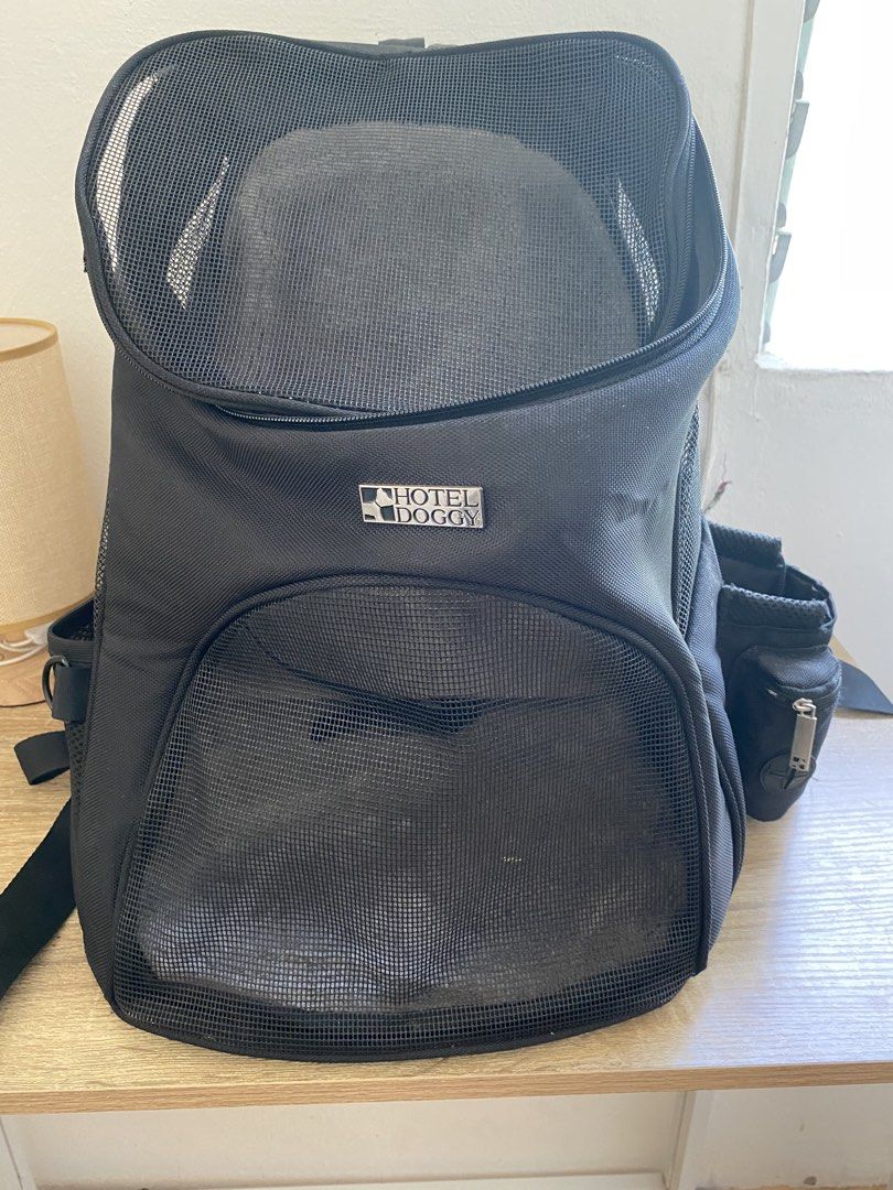 Hotel Doggy Black Mesh Pet Carrier Backpack (Category: Homes & Other Pet Accessories) located in Calamba. Submitted by aninmilo (Listing ID 1465821047, Image 1). Description: - Color: Black - Style: Hotel Doggy pet carrier backpack - Breathable mesh panels on top and front for maximum ventilation - Convenient side pockets for storage - Comfortable, adjustable shoulder straps - Smooth and reliable zipper closure - Ideal for bringing cats or small 
