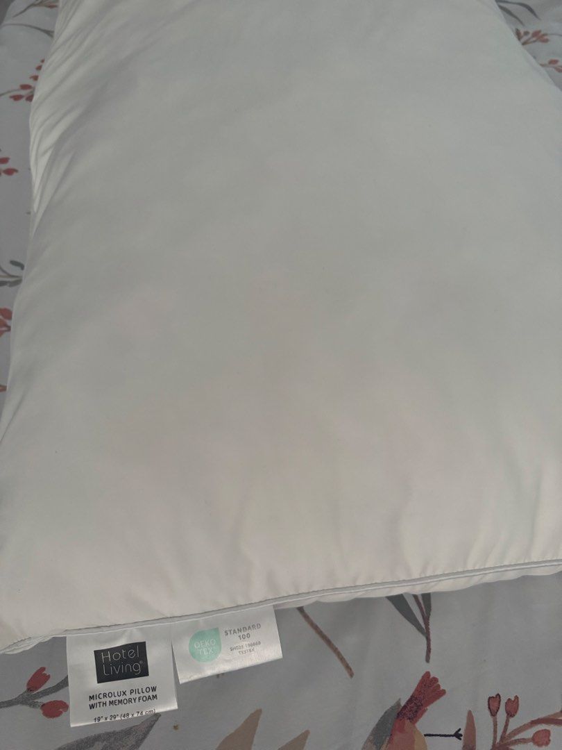 Hotel Living Microlux Pillow with Memory Foam (Category: Bedding & Towels) located in Manila. Submitted by decluterthings888 (Listing ID 1465953343, Image 2). Description: - Brand: Hotel Living Microlux Pillow - Filling: Memory foam inside for superior support - Certification: Standard 100 OEKO-TEX certified materials - Size: Standard 19" x 29" (48 x 74 cm) - Design: Clean white color with stylish piping edges - Feel: Plush, comfortable, and grea