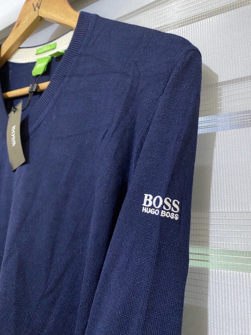 Hugo Boss V-Neck Wool Sweater (Category: Coats, Jackets and Outerwear) located in Calapan. Submitted by metriowendell22 (Listing ID 1465777880, Image 3). Description: - Brand: Hugo Boss - Color: Navy blue - Size: Medium (Made in Turkey) - Material: Water-repellent wool (super comfortable) - Features: V-neck, long sleeves, ribbed cuffs and hem, green square logo tag on sleeve and neck - Condition: Brand new with original store tag attached.