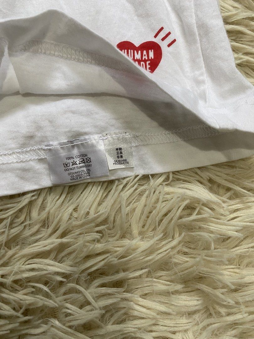 Human Made White Graphic Heart Tee Large (Category: Shirts) located in Manila. Submitted by switchcity (Listing ID 1465898721, Image 3). Description: - Brand: Human Made (Otsumo Co. Ltd.) - Color: White - Size: Large - Material: 100% premium cotton - Design: Classic crew neck with iconic red heart logo near the bottom hem and grey heart graphic print on the inside collar - Condition: Brand new / Excellent everyday basic - Perfect staple piece for