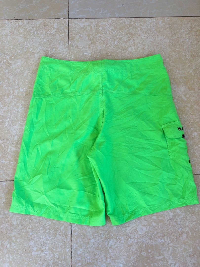 Hurley Neon Green Boardshorts (Category: Swim Trunks & Board Shorts) located in Bacoor. Submitted by davealvare39194 (Listing ID 1465858653, Image 2). Description: - Brand: Hurley - Color: Bright neon green with black details - Material: Lightweight surf fabric - Features: Contrast stitching, right leg flap pocket with logo, black drawstring with reinforced eyelets - Waistband: Wide black waistband with large white Hurley branding inside - Condit