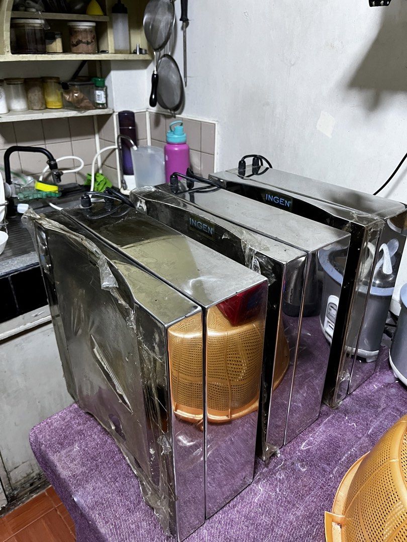 Ingen Stainless Steel Water Purifier System (Category: Water Purifiers & Dispensers) located in Manila. Submitted by samsison6814720 (Listing ID 1465798101, Image 3). Description: - Brand: Ingen stainless steel water purifier setup - Housing: Polished metal cabinet with hinged door (protective plastic film still on parts) - Filtration: Multiple internal cylinder filters (SA-4, SA-11, SA11-PC) - Sterilization: Includes stainless UV sterilizer tube