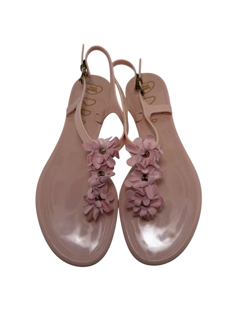 Jelly Bunny (Category: Flats & Sandals) located in Baguio. Submitted by jerome09965737 (Listing ID 1465950186, Image 1). Description: - Brand: Jelly Bunny - Style: Pink jelly sandals with T-strap and adjustable ankle buckle - Details: Cute fabric flower embellishments with small stud centers - Finish: Glossy light pink - Size: US 6 /BRA 35 (stamped on bottom) - Condition: Good overall with some dirt on soles from wear (refer to pictures for exact