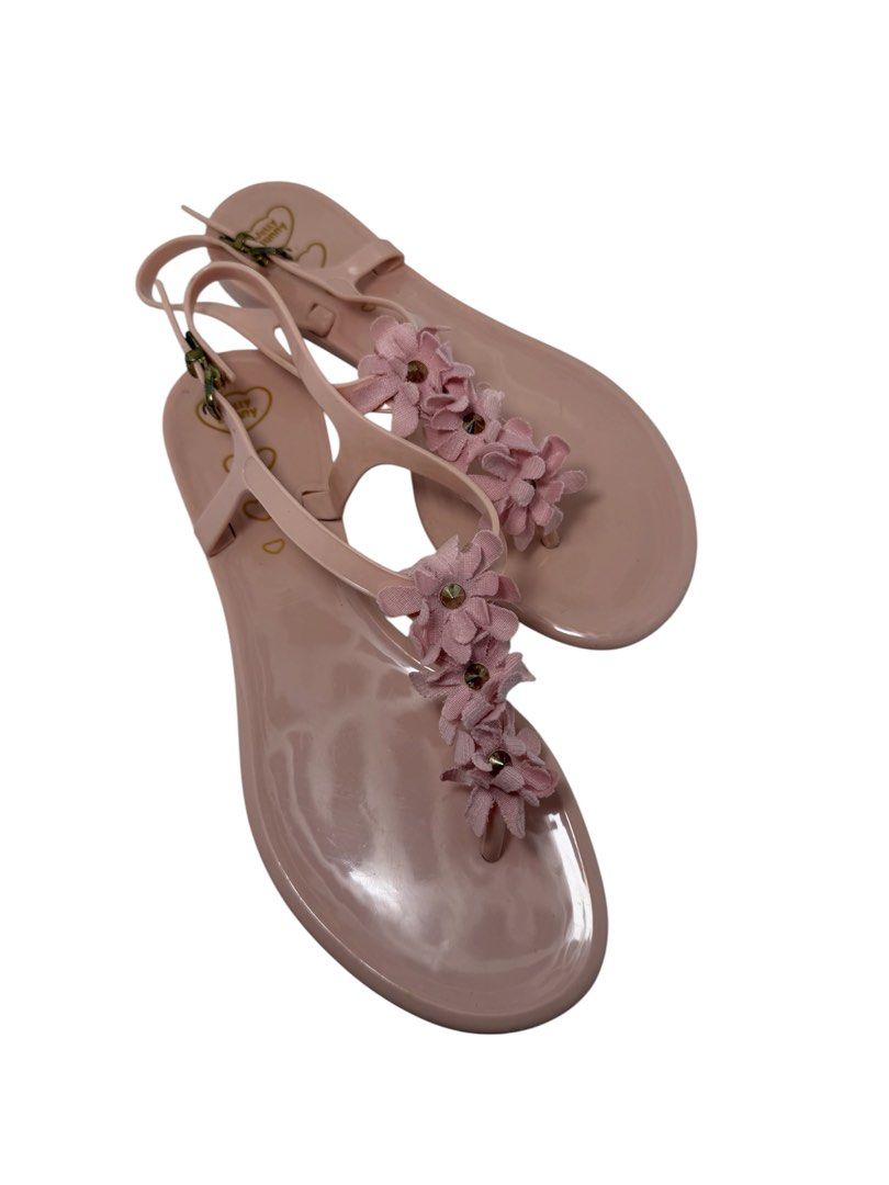 Jelly Bunny (Category: Flats & Sandals) located in Baguio. Submitted by jerome09965737 (Listing ID 1465950186, Image 2). Description: - Brand: Jelly Bunny - Style: Pink jelly sandals with T-strap and adjustable ankle buckle - Details: Cute fabric flower embellishments with small stud centers - Finish: Glossy light pink - Size: US 6 /BRA 35 (stamped on bottom) - Condition: Good overall with some dirt on soles from wear (refer to pictures for exact