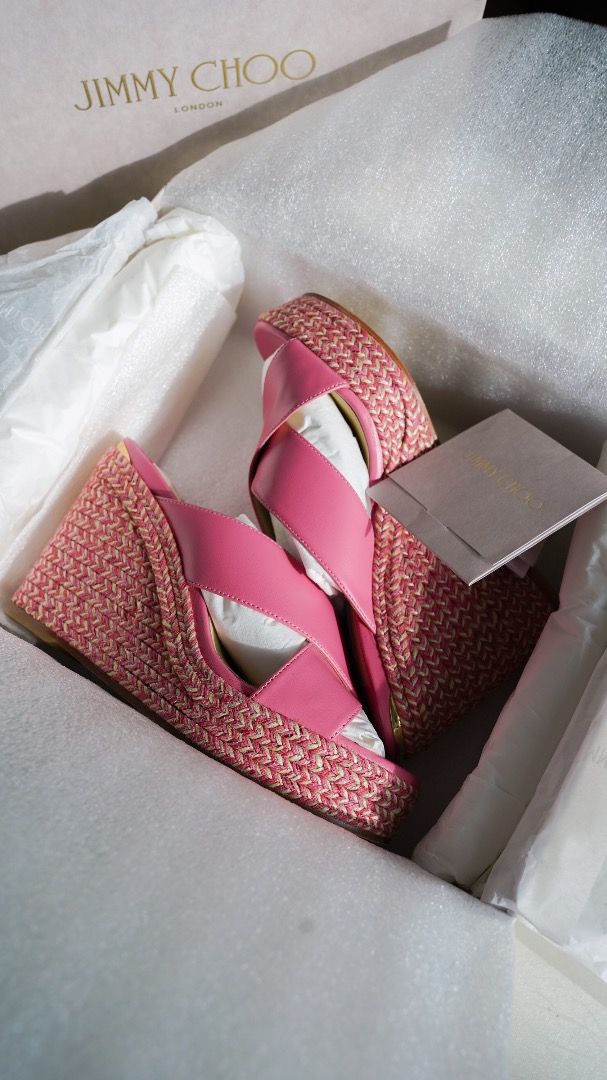 Jimmy Choo Pink Wedge Sandals (Category: Wedges) located in Pasig City. Submitted by laagn.ph (Listing ID 1465763210, Image 2). Description: - Brand: Jimmy Choo - Type: Wedge sandals with woven espadrille platforms - Material: Pink leather with chic crisscross straps - Condition: Brand new, unworn, with internal packaging preserved - Inclusions: Original branded box, dust wrap, and tag included.