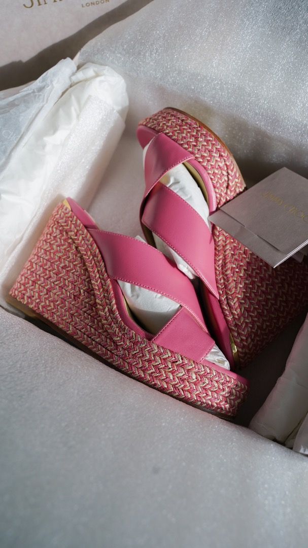 Jimmy Choo Pink Wedge Sandals (Category: Wedges) located in Pasig City. Submitted by laagn.ph (Listing ID 1465763210, Image 3). Description: - Brand: Jimmy Choo - Type: Wedge sandals with woven espadrille platforms - Material: Pink leather with chic crisscross straps - Condition: Brand new, unworn, with internal packaging preserved - Inclusions: Original branded box, dust wrap, and tag included.