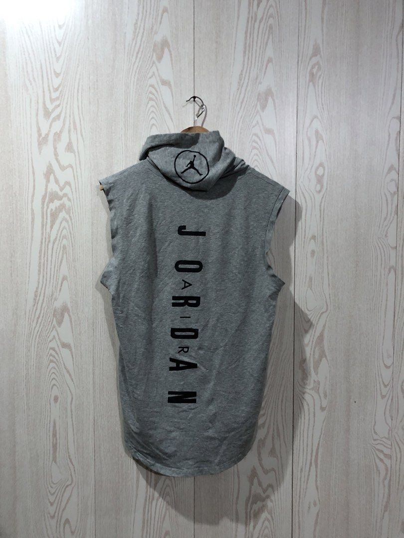 Jordan Sleeveless Hoodie Grey (Category: Activewear) located in Magsaysay. Submitted by ryns_thrifting (Listing ID 1465894716, Image 2). Description: - Brand: Jordan - Color: Grey - Style: Sleeveless hoodie with attached drawstrings and high-low curved hem - Material: 100% polyester - Details: Embroidered Jumpman logo on chest, large vertical Jordan lettering and circular Jumpman logo on the back - Condition: Great overall condition with no major