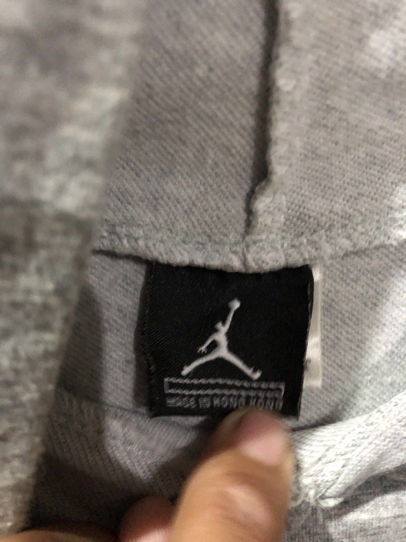 Jordan Sleeveless Hoodie Grey (Category: Activewear) located in Magsaysay. Submitted by ryns_thrifting (Listing ID 1465894716, Image 3). Description: - Brand: Jordan - Color: Grey - Style: Sleeveless hoodie with attached drawstrings and high-low curved hem - Material: 100% polyester - Details: Embroidered Jumpman logo on chest, large vertical Jordan lettering and circular Jumpman logo on the back - Condition: Great overall condition with no major