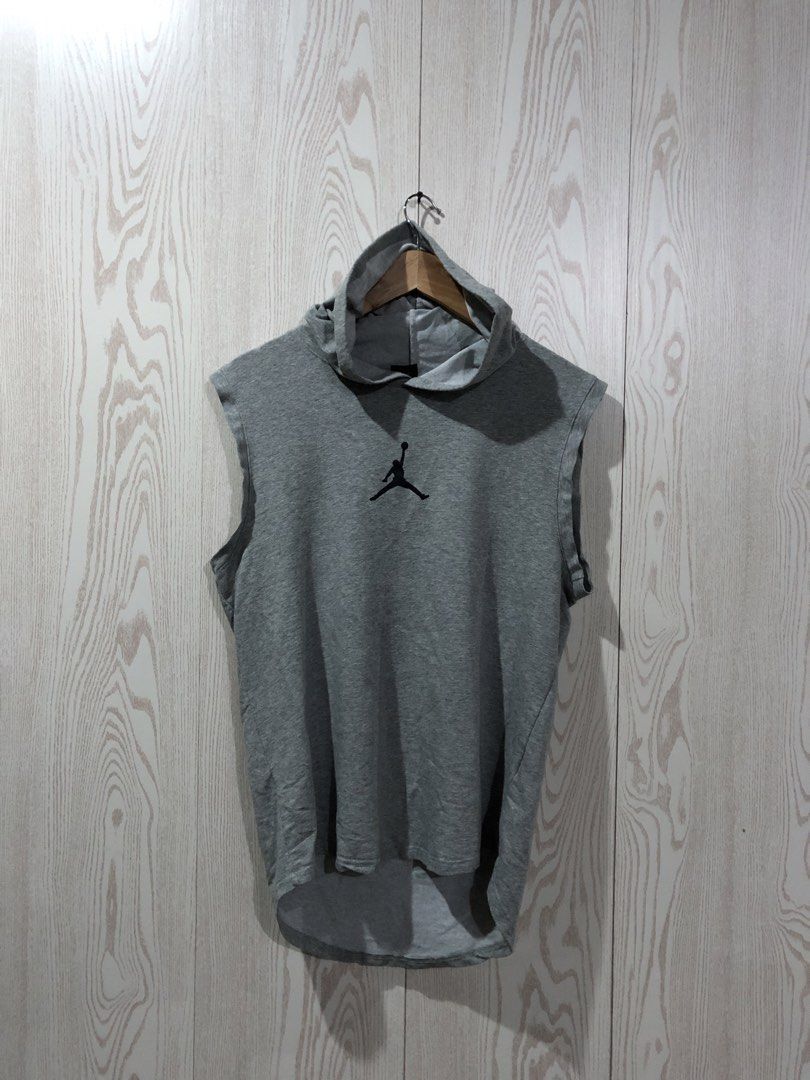 Jordan Sleeveless Hoodie Grey (Category: Activewear) located in Magsaysay. Submitted by ryns_thrifting (Listing ID 1465894716, Image 1). Description: - Brand: Jordan - Color: Grey - Style: Sleeveless hoodie with attached drawstrings and high-low curved hem - Material: 100% polyester - Details: Embroidered Jumpman logo on chest, large vertical Jordan lettering and circular Jumpman logo on the back - Condition: Great overall condition with no major