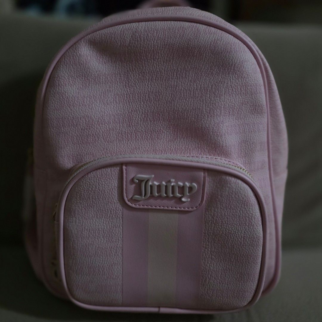 Juicy Couture Dreamy Juicy Medium Backpack (Category: Backpacks) located in Manila. Submitted by carnastraea (Listing ID 1465899140, Image 1). Description: Add the ultimate Y2K vibe to your outfit with this gorgeous Juicy Couture Dreamy Juicy Backpack! Crafted from high-quality pink faux leather with a beautiful, subtle textured grain, this bag features iconic Juicy styling. The front pocket showcases an embossed vertical stripe pattern topped wi