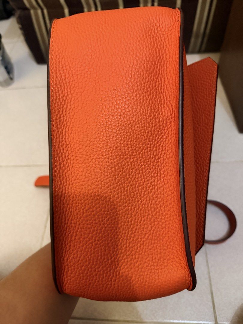 Jypsiere Orange Shoulder Bag with Silver Hardware (Category: Luxury Bags & Wallets) located in Manila. Submitted by gizmoi (Listing ID 1465825957, Image 2). Description: - shoulder bag in a stunning bright orange pebble leather - Sleek silver hardware closures and accents - Clean interior lining equipped with convenient zipper and slip pockets - Includes an adjustable matching leather strap for versatile styling .