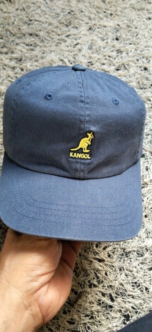 Kangol Blue Baseball Cap with Brown Leather Strap (Category: Caps & Hats) located in Paranaque City. Submitted by michael-08 (Listing ID 1465885398, Image 1). Description: - Brand: Kangol - Color: Blue cotton with yellow embroidered kangaroo logo - Closure: Adjustable brown leather strapback with metal clasp - Design: Classic curved brim and stitched top eyelets - Condition: Clean, excellent everyday casual staple - Shipping: Fast shipping from a