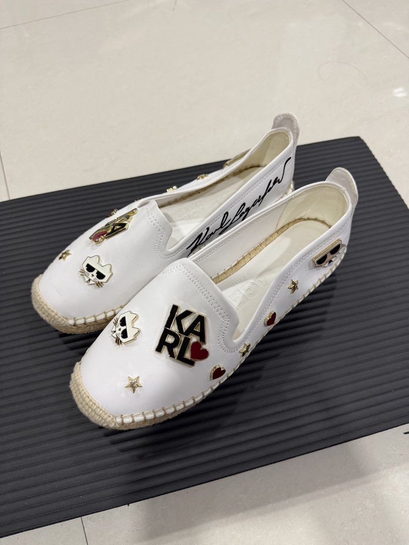 Karl Lagerfeld White Leather Espadrilles Flat Shoes (Category: Flats & Sandals) located in Manila. Submitted by imprincessg888 (Listing ID 1465863468, Image 1). Description: - Brand: Karl Lagerfeld - Style: Slip-on leather espadrilles - Color: Clean white - Details: Jute trim, metal star, heart, and cat face pins, plus Karl logo badge - Branding: Large embroidered signature along the side - Condition: Pristine, very stylish summer flats.