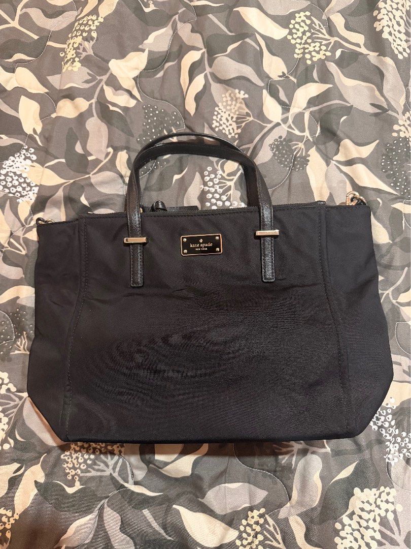 Kate Spade Black Nylon Tote Bag (Category: Tote Bags) located in Mexico. Submitted by anythingluxe (Listing ID 1465912429, Image 1). Description: - Brand: Kate Spade - Material: Lightweight black nylon with gold-tone hardware and metal logo plaque - Closure: Secure zip top closure - Features: Sturdy black handles, structured base, and clean interior/exterior - Capacity: Spacious everyday carryall, easily fits laptops, wallets, and daily essential