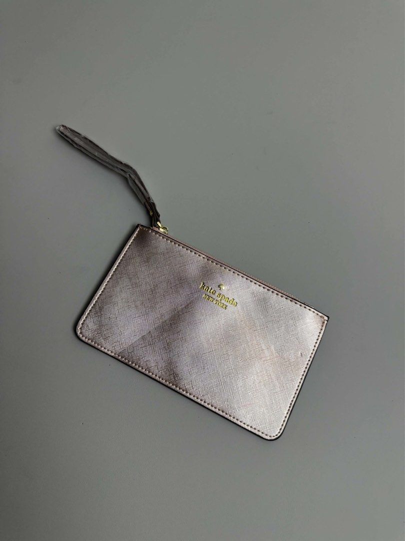 KATE SPADE NEW YORK (Category: Purses & Pouches) located in Guagua. Submitted by sweetboyy (Listing ID 1465767998, Image 2). Description: KATE SPADE NEW YORK METALLIC SILVER SAFFIANO LEATHER WRISTLET POUCH.