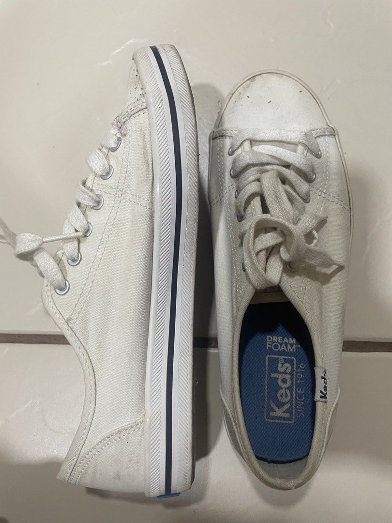 Keds Dream Foam White Canvas Sneakers (Category: Sneakers) located in Mandaluyong City. Submitted by annab11 (Listing ID 1465908227, Image 2). Description: - Brand: Keds - Color: White canvas with striped rubber midsoles - Comfort: Blue Dream Foam insoles for extra cushioning - Design: Classic low-top with traditional lace-up front and silver eyelets - Condition: Normal signs of wear on fabric and soles, outsoles still have decent grip - Style: G