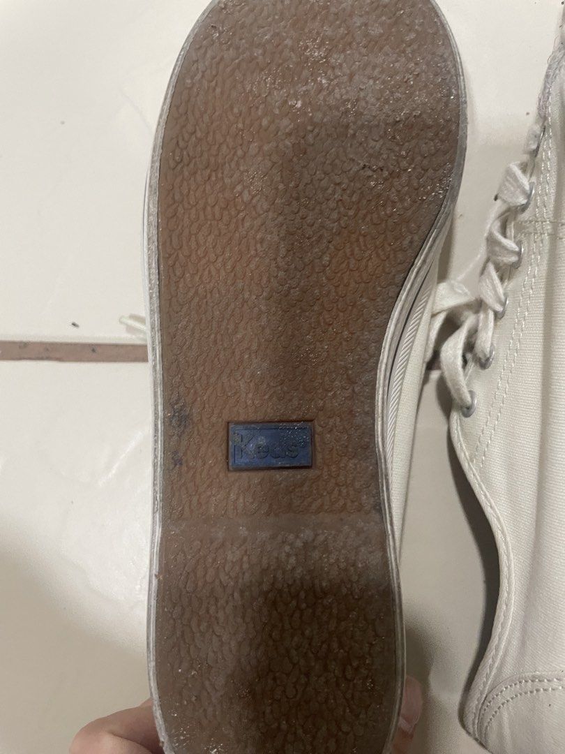 Keds Dream Foam White Canvas Sneakers (Category: Sneakers) located in Mandaluyong City. Submitted by annab11 (Listing ID 1465908227, Image 3). Description: - Brand: Keds - Color: White canvas with striped rubber midsoles - Comfort: Blue Dream Foam insoles for extra cushioning - Design: Classic low-top with traditional lace-up front and silver eyelets - Condition: Normal signs of wear on fabric and soles, outsoles still have decent grip - Style: G