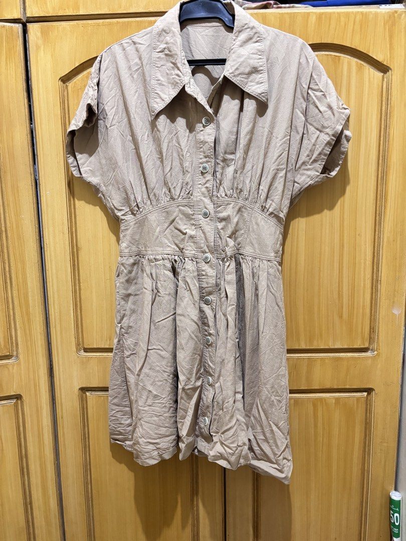 Khaki Button-Down Mini Polo Dress (Category: Dresses) located in Makati City. Submitted by passinggems (Listing ID 1465930627, Image 3). Description: - Waist 28-28.5 inches - Length 34 inches - Color: Beige / Neutral Khaki - Short-sleeve shirt dress with collared neckline and front button closure - Fitted paneled waistband with gathered details and a flared knee-length skirt - MOP: GCash or BDO - MOD: LBC or same-day delivery only. SF shouldered 