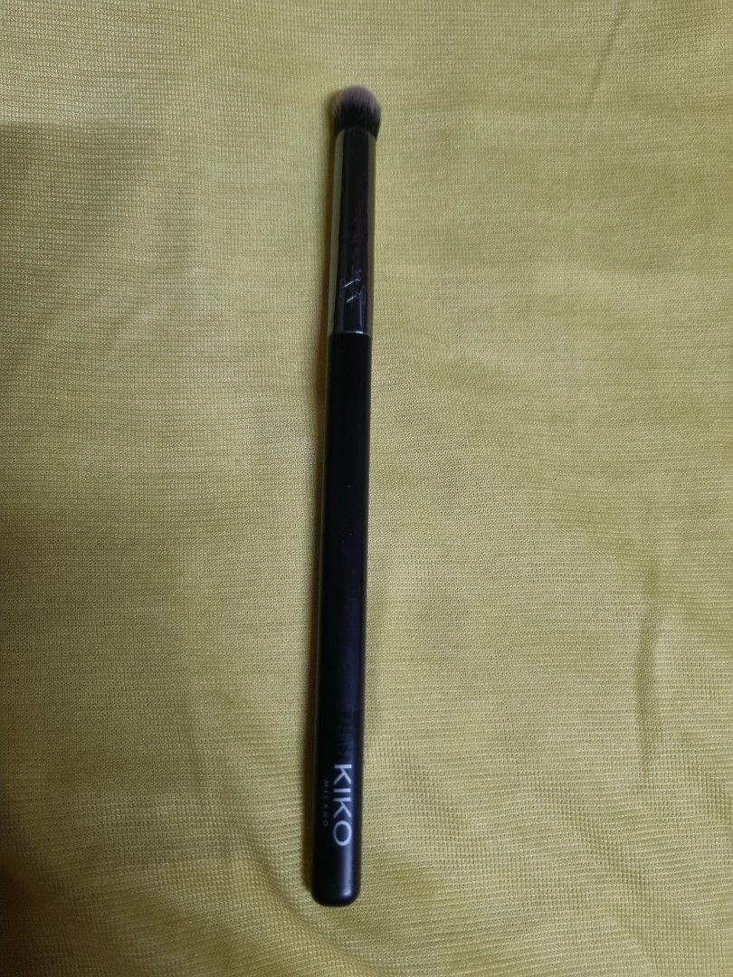 Kiko Milano Eyeshadow Brush (Category: Makeup) located in Manila. Submitted by monya111 (Listing ID 1465762701, Image 1). Description: - Brand: Kiko Milano - Item: Eye makeup brush - Design: Sleek black handle with silver ferrule - Bristles: Soft, shaped for precise blending and application - Condition: Barely used, stored in a clean drawer - Perfect for daily makeup kits and on-the-go touch-ups.