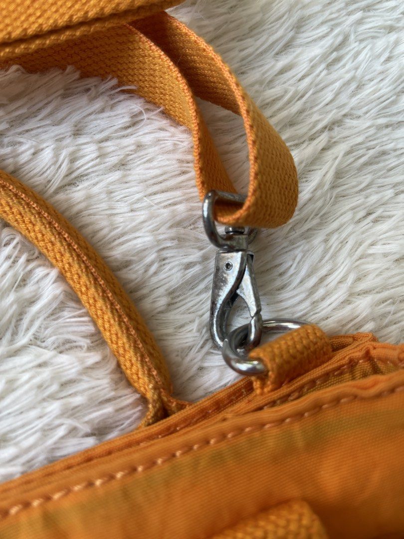 Kipling Caralis Sunset Yellow Bag (Category: Shoulder Bags) located in Malolos. Submitted by ishnnt (Listing ID 1465908433, Image 2). Description: - Brand: Kipling Basic Collection - Style: Caralis Tote Bag (K2062918G) - Color: Bright Yellow - Material: Durable crinkle nylon with round Kipling logo patch - Features: Double top handles, adjustable/removable shoulder strap, and front slip pocket - Inclusion: Iconic furry monkey keychain - Condition