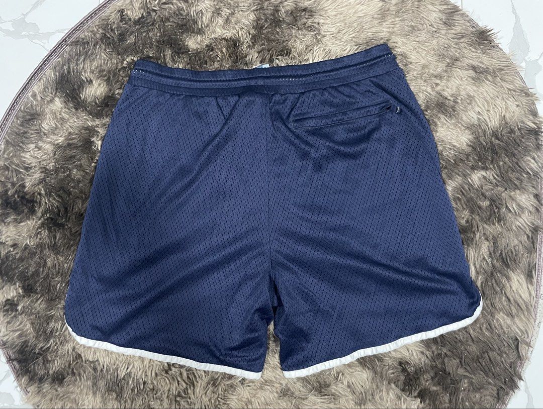 Kith Navy Blue Mesh Shorts Size M (Category: Shorts) located in Calapan. Submitted by lucasthrifts (Listing ID 1465922650, Image 2). Description: - Brand: Kith - Item: Mesh Shorts - Color: Navy Blue with white contrast piping - Size: Medium (Tag attached) - Condition: Presentable - Features: Breathable mesh fabric, white waist drawstrings, large Kith logo on left leg, and a back zippered pocket with branded hardware -30-36 waist.